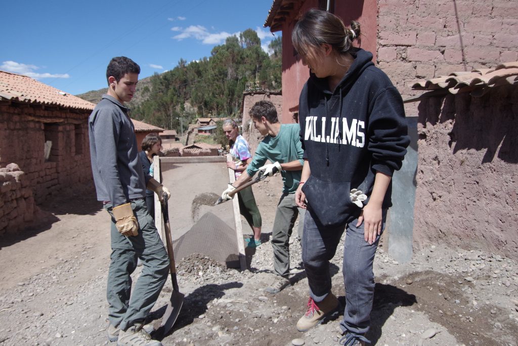 A group sifting sand for the final finish on the walls