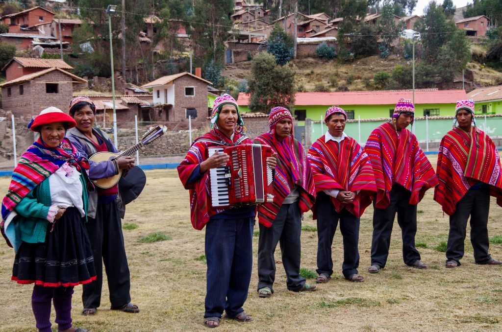 Qenqueños play and sing in Quechua to welcome us